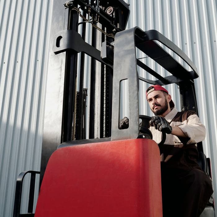 Forklift operator in a warehouse